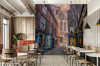 The mural shows an old European street with a cathedral.

