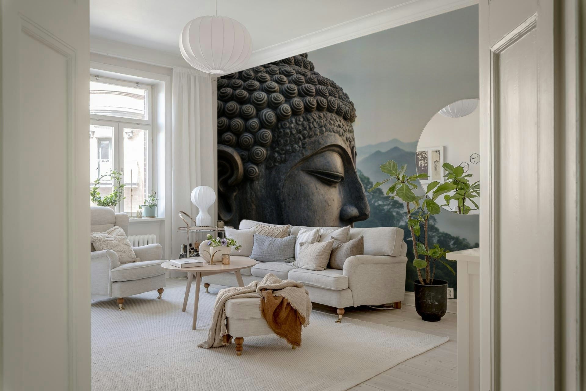 Neutral color palette wallpaper with Buddha imagery in a yoga studio setting.