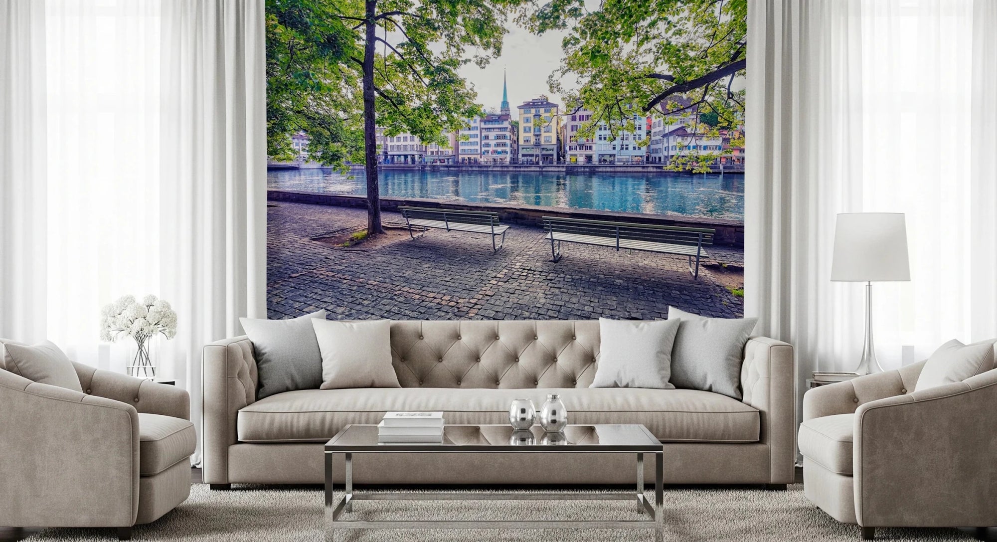 Zurich River Scene wallpaper mural of turquoise river and old town houses behind a beige tufted sofa and armchairs